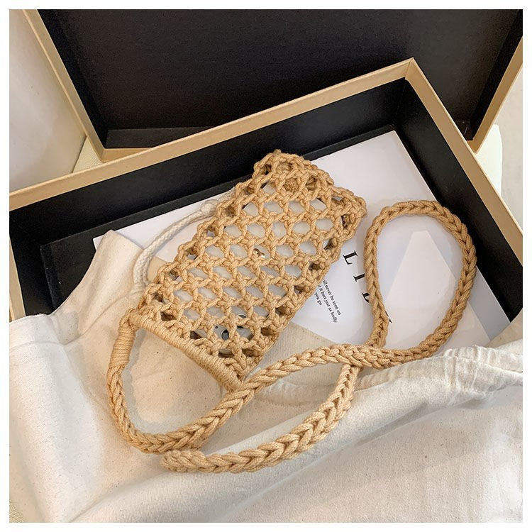 Woven handbag with a strap on a white surface
