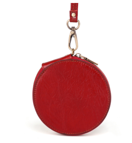 Red round leather pouch with a keychain on a white background