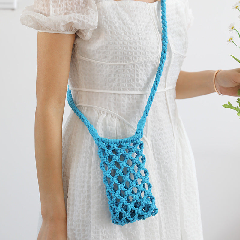 Person wearing a white dress holding a blue mesh bag against a white background