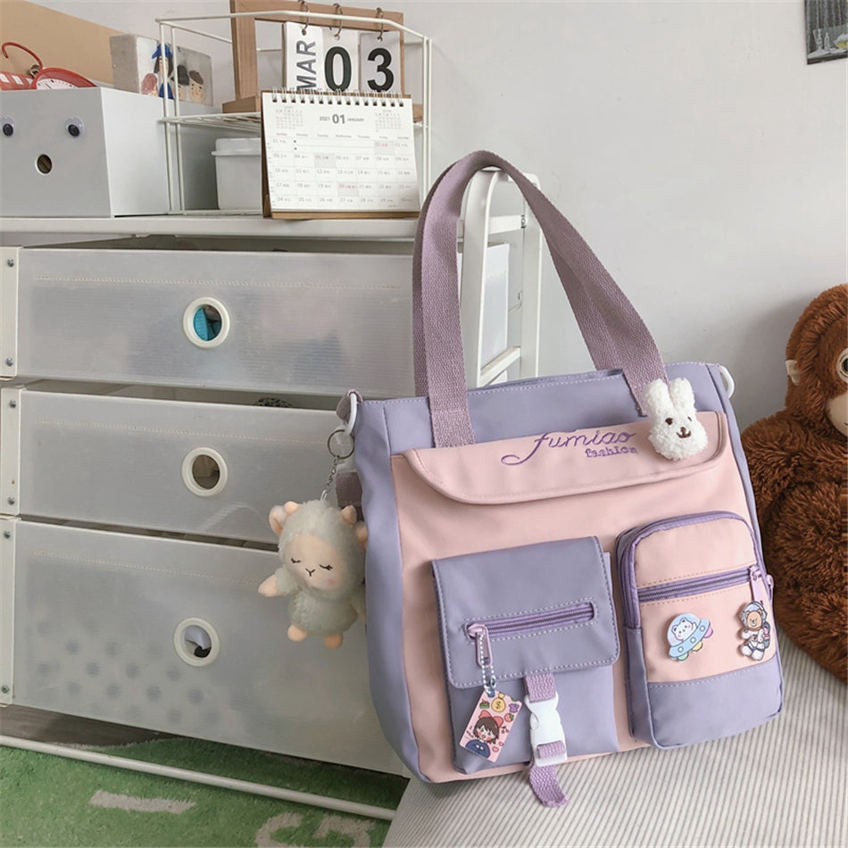 Pink and purple bag with plush toys on a dresser