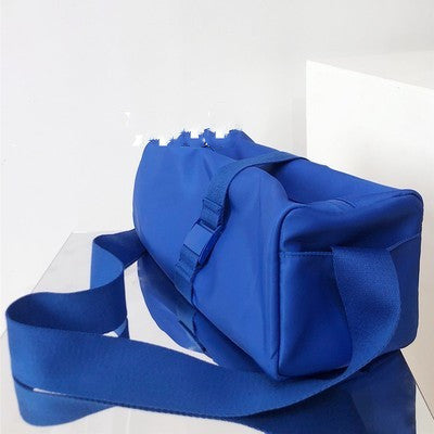Blue duffel bag with a strap on a white background