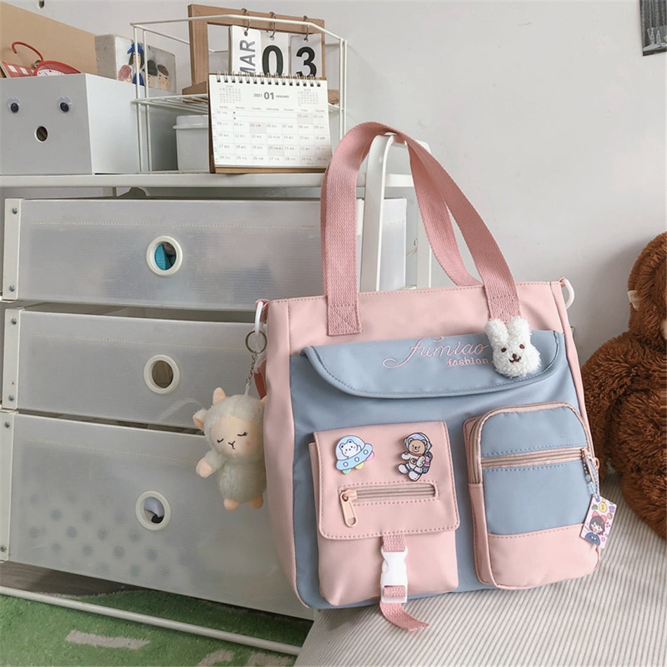 Pink and blue bag with plush toys on a dresser