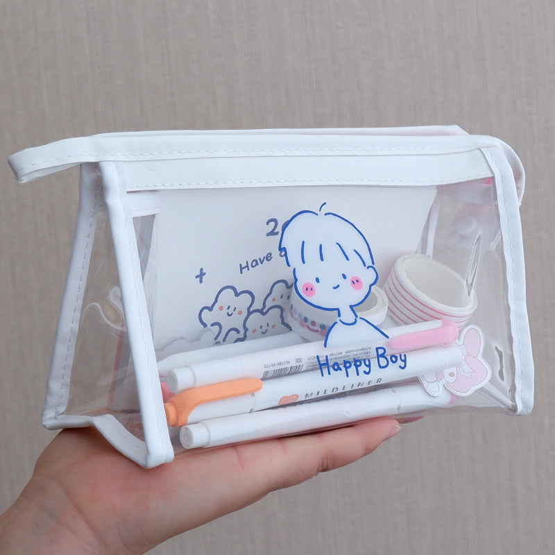 Clear pouch with stationery items and cartoon design held by a hand against a neutral background