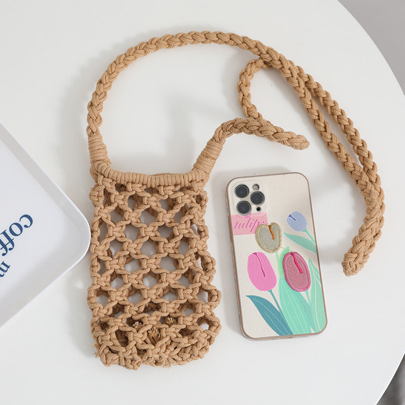 Beige woven bag with a floral phone case on a white surface