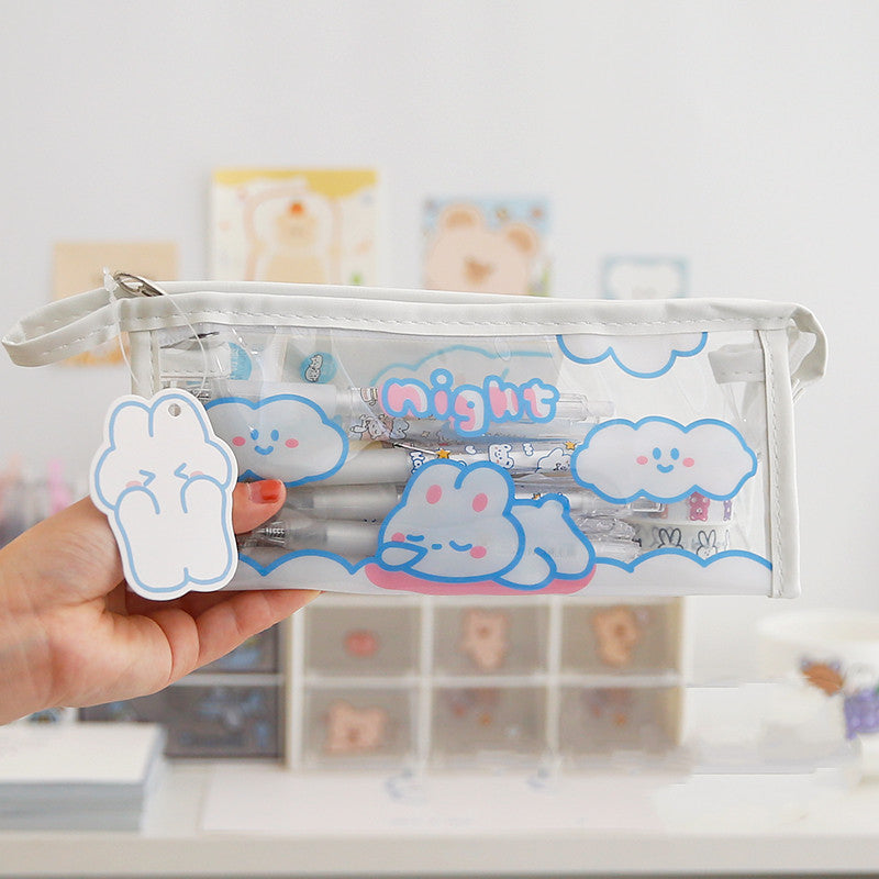 Clear pencil case with cloud designs and 'night' text held by a hand.