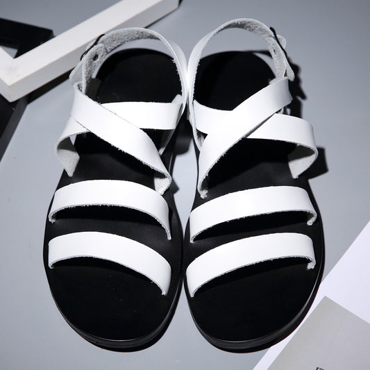 Black and white sandals on a gray background