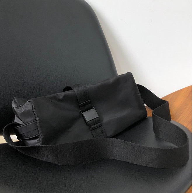 Black waist bag with a strap on a chair