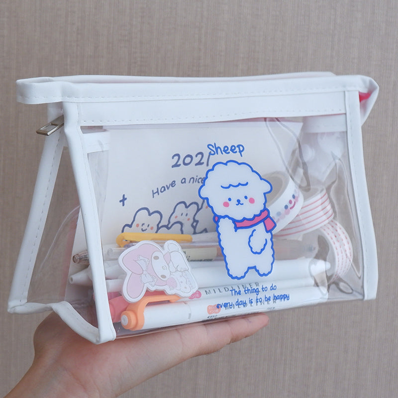Clear pouch with cartoon sheep design held by a hand against a neutral background