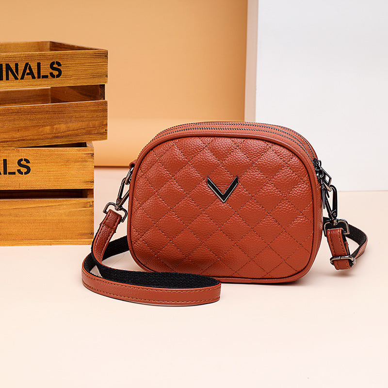 Brown quilted handbag with a visible brand logo on a light background